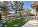 Backyard view of yard, pool, and mature landscaping at 8649 Robinson Ridge Dr, Las Vegas, NV 89117