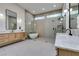 Modern bathroom with dual sinks, large soaking tub, and glass-enclosed showers at 8649 Robinson Ridge Dr, Las Vegas, NV 89117