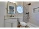 Modern bathroom featuring gray tiled shower, octagon window, and white vanity at 8649 Robinson Ridge Dr, Las Vegas, NV 89117