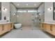 Sleek bathroom features a soaking tub and glass-enclosed shower between two modern vanities at 8649 Robinson Ridge Dr, Las Vegas, NV 89117