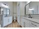 Bathroom featuring double sink vanity with white cabinets, large mirrors, and sleek fixtures at 8649 Robinson Ridge Dr, Las Vegas, NV 89117