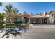 Inviting single-story home featuring a three-car garage, desert landscaping, and tile roof at 8649 Robinson Ridge Dr, Las Vegas, NV 89117