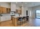 Bright kitchen featuring modern appliances, light wood cabinets, and a large center island with barstool seating at 8649 Robinson Ridge Dr, Las Vegas, NV 89117