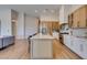 Bright kitchen featuring modern appliances, light wood cabinets, and a large center island with barstool seating at 8649 Robinson Ridge Dr, Las Vegas, NV 89117