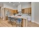 Bright kitchen featuring modern appliances, light wood cabinets, and a large center island with barstool seating at 8649 Robinson Ridge Dr, Las Vegas, NV 89117