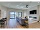 Open living area with a modern fireplace, large windows with pool view, and sleek ceiling fan at 8649 Robinson Ridge Dr, Las Vegas, NV 89117