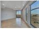 Bedroom featuring large windows with cityscape views, balcony access, and neutral color palette at 9103 Alta Dr # 404, Las Vegas, NV 89145