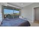 Comfortable bedroom with city views from balcony with iron railing and a large comfortable bed at 9103 Alta Dr # 404, Las Vegas, NV 89145