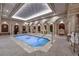 Opulent indoor pool featuring stone columns, mosaic tile, and intricate ceiling design at 9103 Alta Dr # 404, Las Vegas, NV 89145