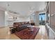 Living room and bar area with tile floors, modern ceiling fans, and abundant natural light at 9103 Alta Dr # 404, Las Vegas, NV 89145