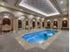 Luxurious indoor pool area featuring roman columns, archways, statues, and decorative lighting at 9103 Alta Dr # 404, Las Vegas, NV 89145