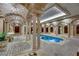 Beautiful indoor pool with columns, archways, and a uniquely designed tile floor at 9103 Alta Dr # 404, Las Vegas, NV 89145