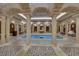 Indoor pool boasts detailed columns, archways, and unique tile design, creating a luxurious retreat at 9103 Alta Dr # 404, Las Vegas, NV 89145