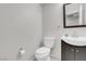 Small half-bathroom with modern fixtures, including a vanity and toilet at 9278 Hainsworth Ave, Las Vegas, NV 89148