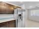 Bright kitchen featuring stainless steel refrigerator and wooden cabinets at 9278 Hainsworth Ave, Las Vegas, NV 89148