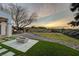 Backyard featuring a modern fire pit, grassy areas, desert landscaping, and a relaxing hot tub at 1 Club Vista Dr, Henderson, NV 89052