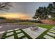 Backyard featuring a modern fire pit, grassy areas, desert landscaping, and an open view at 1 Club Vista Dr, Henderson, NV 89052