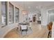 Open dining area featuring large windows, a round table, and seamless flow to the kitchen and living spaces at 1 Club Vista Dr, Henderson, NV 89052