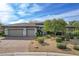 Beautiful home exterior with a three-car garage, well-manicured landscaping, and a tile roof at 1 Club Vista Dr, Henderson, NV 89052