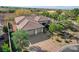 Aerial view of a home with a tile roof, desert landscaping, three-car garage, and circular driveway at 1 Club Vista Dr, Henderson, NV 89052