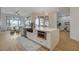 Spacious kitchen island with stainless appliances and black sink overlooks the living area with large windows at 1 Club Vista Dr, Henderson, NV 89052