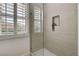 Modern shower featuring a glass door, neutral tile, and a built-in niche for storage at 1 Club Vista Dr, Henderson, NV 89052