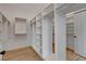 Bright walk-in closet featuring custom shelving and wooden floors, designed for optimal storage at 1 Club Vista Dr, Henderson, NV 89052