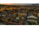 A stunning aerial view of a home highlighting its backyard pool and the community at sunset at 10233 Madison Grove Ave, Las Vegas, NV 89166