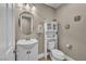 Powder bathroom featuring a pedestal sink, white fixtures and neutral paint at 10233 Madison Grove Ave, Las Vegas, NV 89166