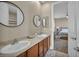 Bathroom featuring double sinks, and an arched opening to the bedroom at 10233 Madison Grove Ave, Las Vegas, NV 89166