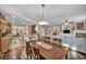 Dining area leading to an open kitchen and living room, with hardwood floors and abundant natural light at 10233 Madison Grove Ave, Las Vegas, NV 89166