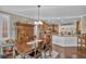 Open-concept dining room flowing into the kitchen, with hardwood floors and a large hutch at 10233 Madison Grove Ave, Las Vegas, NV 89166