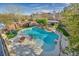 Backyard pool featuring a waterfall, fire pit area, seating, and landscaped yard at 10233 Madison Grove Ave, Las Vegas, NV 89166