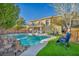 Beautiful backyard with a large pool, stone waterfall feature, and lounge chairs at 10233 Madison Grove Ave, Las Vegas, NV 89166