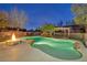 The backyard features a swimming pool, hot tub, and a fire pit at 10233 Madison Grove Ave, Las Vegas, NV 89166