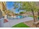 Beautiful backyard with pool featuring a safety fence, patio, and desert landscaping at 10233 Madison Grove Ave, Las Vegas, NV 89166