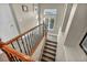 Carpeted staircase with wood railing and wrought iron balusters leading to the upper level at 10233 Madison Grove Ave, Las Vegas, NV 89166