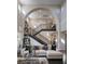 Grand foyer showcasing a soaring archway, elegant staircase, and a bright, open living space at 10305 Orkiney Dr, Las Vegas, NV 89144