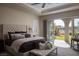 Serene main bedroom with tray ceiling, sitting area, and access to the outdoor patio at 10305 Orkiney Dr, Las Vegas, NV 89144