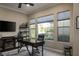 Well-lit home office features a ceiling fan, neutral walls, and built-in shelving at 10305 Orkiney Dr, Las Vegas, NV 89144