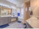 Bright bathroom featuring double sinks, vanity, separate shower and soaking tub at 10446 Abbotsbury Dr, Las Vegas, NV 89135