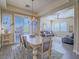 Bright dining area with a chandelier, access to the backyard, and an open layout to the living room at 10446 Abbotsbury Dr, Las Vegas, NV 89135