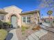 Charming home exterior featuring a landscaped walkway, stone accents, and a well-maintained yard at 10446 Abbotsbury Dr, Las Vegas, NV 89135