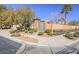 Landscaped front yard with lush plants and attractive curb appeal at 10446 Abbotsbury Dr, Las Vegas, NV 89135