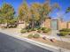 Charming single-story home with a gated entrance, mature trees, and manicured landscaping at 10446 Abbotsbury Dr, Las Vegas, NV 89135