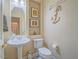 This powder room features a pedestal sink, decorative anchor art, and a neutral color palette at 10446 Abbotsbury Dr, Las Vegas, NV 89135