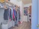 Walk-in closet featuring wood-look tile floor, ample storage, and built-in shelving at 10446 Abbotsbury Dr, Las Vegas, NV 89135