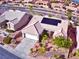 Aerial view of a desert landscaped home featuring solar panels, concrete driveway, and a two-car garage at 10528 Cogswell Ave, Las Vegas, NV 89134