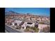 Expansive community shot featuring desert landscaping and mountain views under a clear blue sky at 10528 Cogswell Ave, Las Vegas, NV 89134