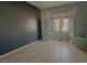 Cozy main bedroom with a bay window, neutral curtains, and smooth laminate flooring at 10528 Cogswell Ave, Las Vegas, NV 89134